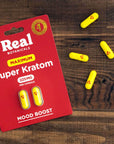 Maxium Strenth Kratom capsules spread out on counter
