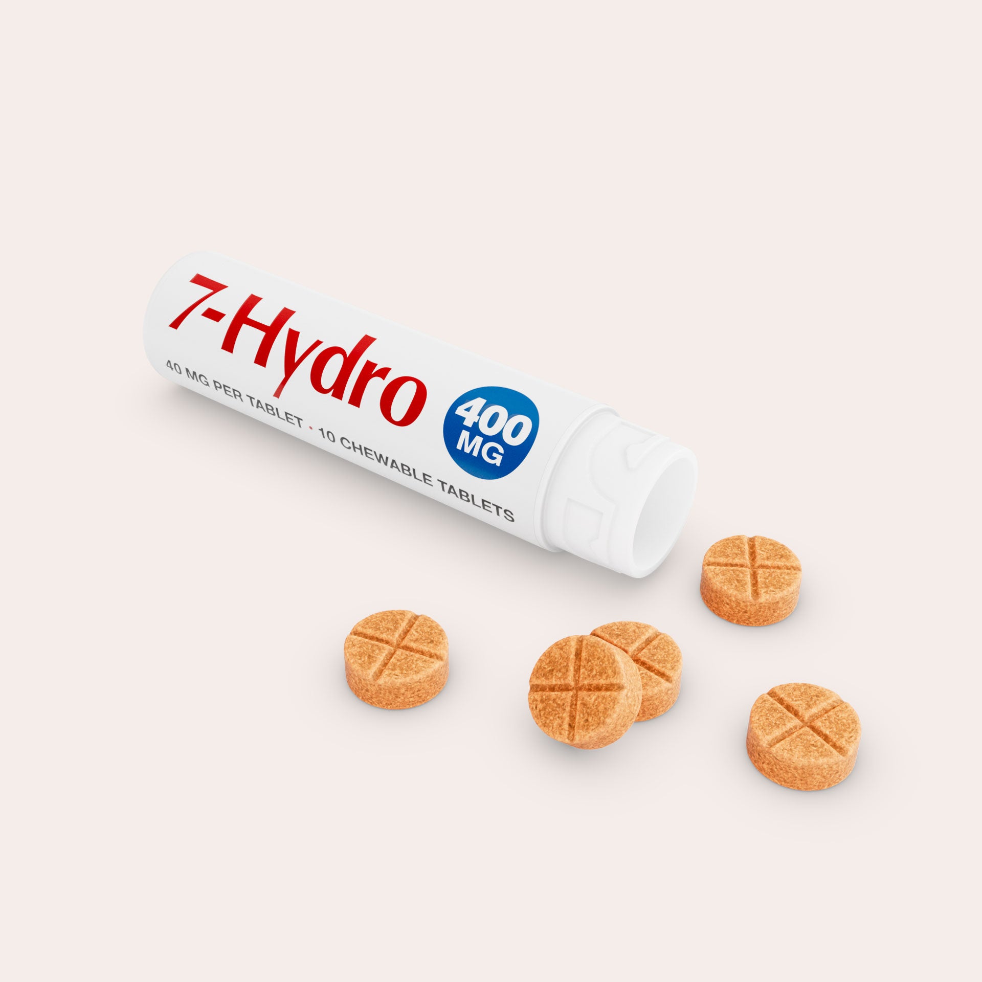 A white tube labeled 7-Hydro 400 MG lies open, with five round, orange chewable tablets spilled out on a light background. The tablets have a cross pattern on top.