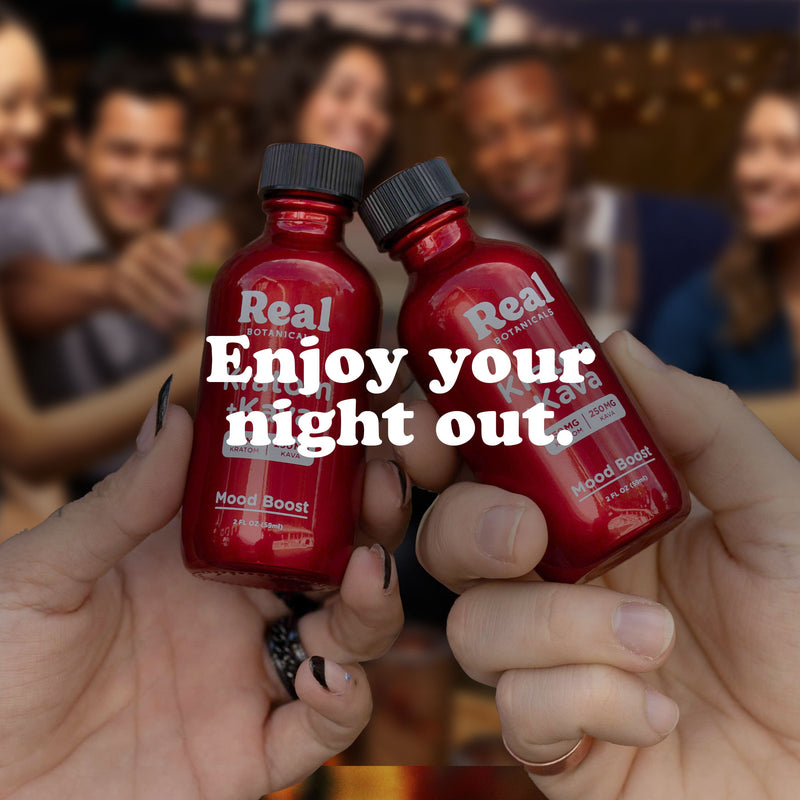 Two hands holding red Real Botanicals bottles with text 'Enjoy your night out,' while a group of friends smiles and celebrates in the background.