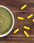 Maximum Strength Kratom capsules spread out on cunter