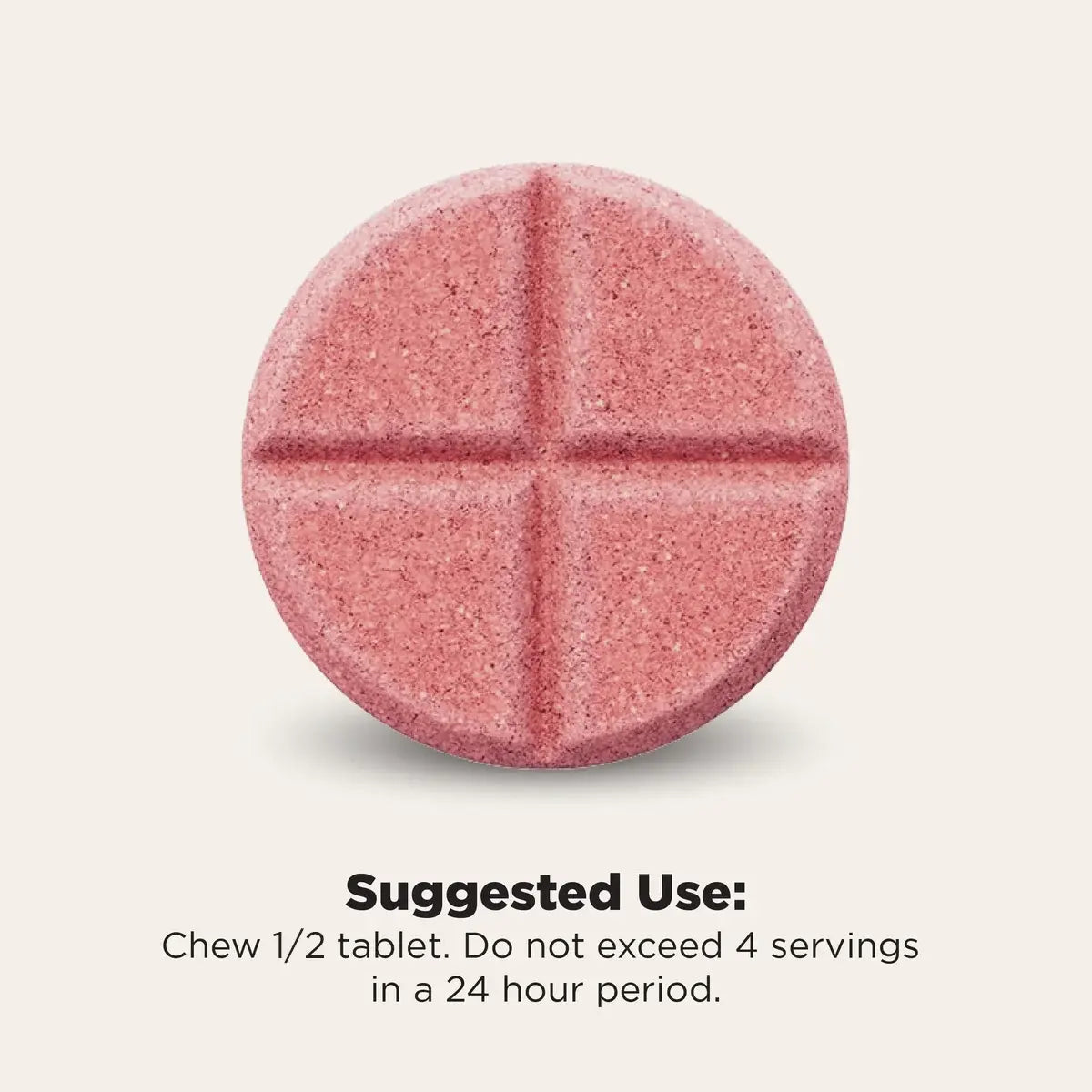 A single round pink tablet with a cross-shaped score line, shown on a light beige background with text below reading 'Suggested Use: Chew 1/2 tablet. Do not exceed 4 servings in a 24 hour period.