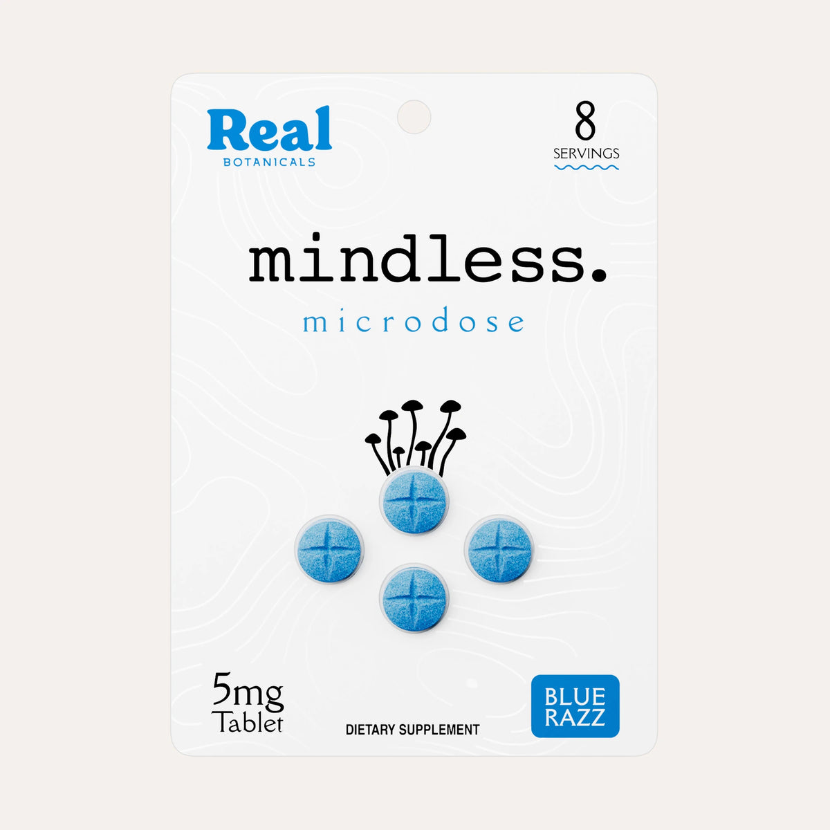 A package of Real Botanicals 'mindless.' microdose dietary supplement, featuring a white card with blue and black text, a graphic of four blue tablets, and a small 'BLUE RAZZ' logo in the bottom right corner, set against a light beige background.