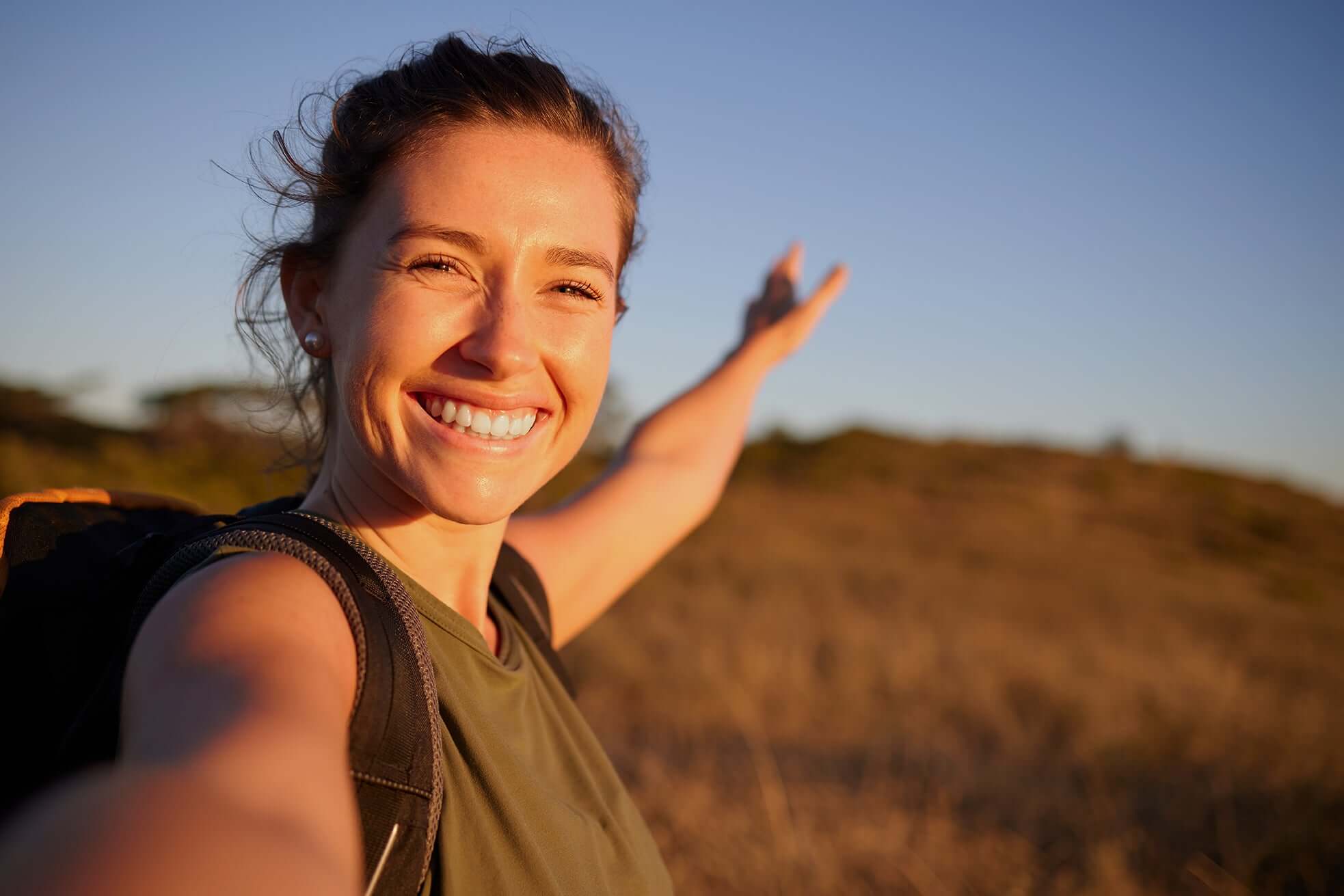 happy woman hiking - Real Botanicals