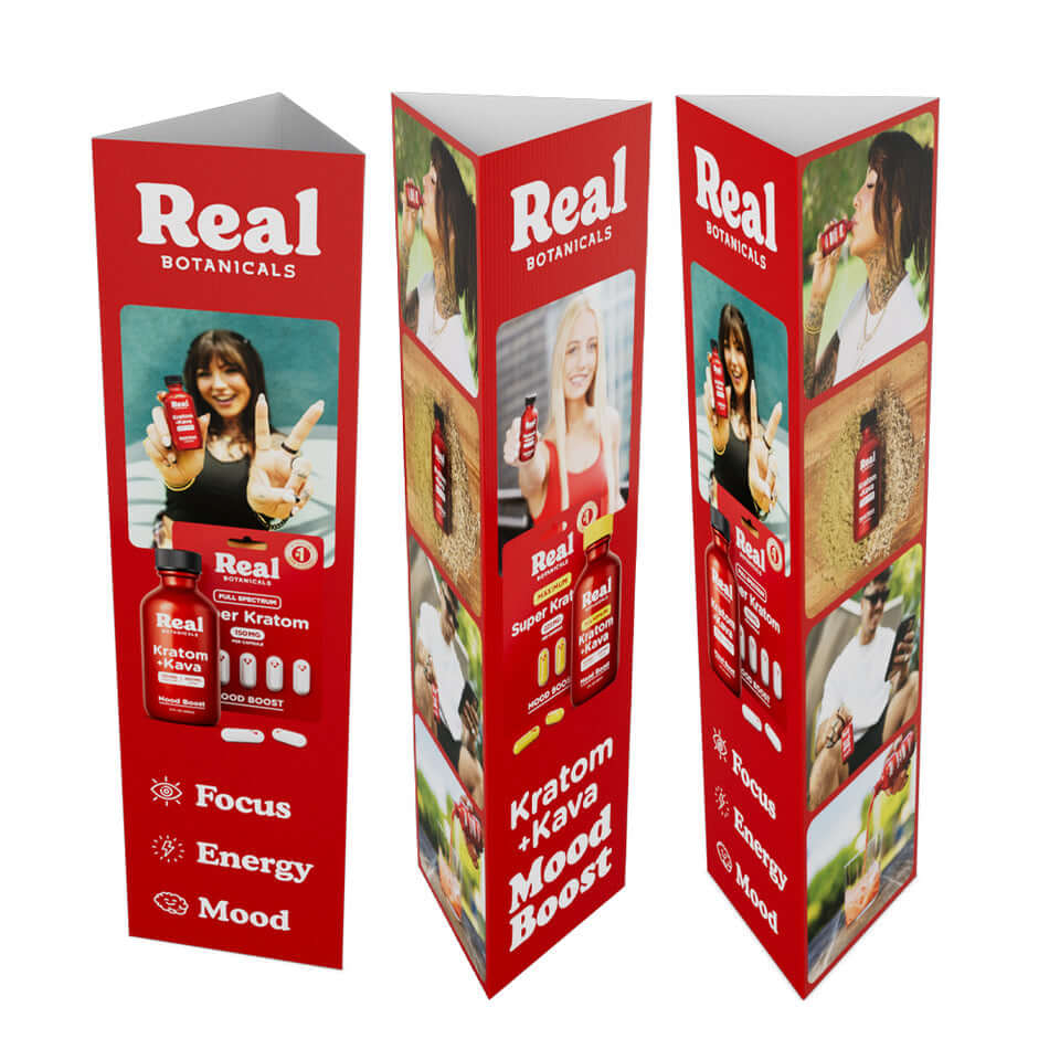 Three red promotional stands for 'Real Botanicals' products on a white background
