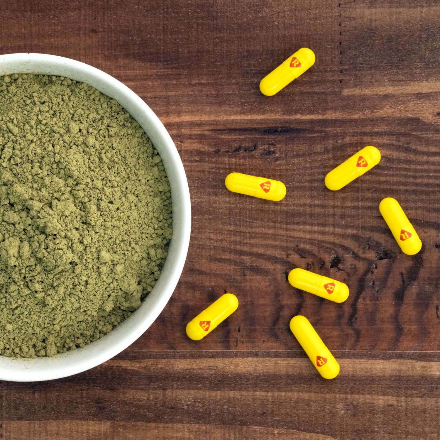 Maximum Strength Kratom capsules spread out on cunter